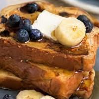 Blueberry French Toast · Blueberries and French toast with butter and syrup