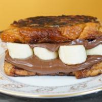 Banana Nutella French Toast Sandwich · 2 slices of French toast with butter and syrup. This is the bomb!!