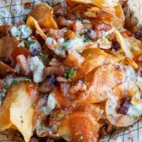 Buffalo Chachos · Potato chips, applewood-smoked bacon, sriracha buffalo, blue cheese sauce & crumbles, chives