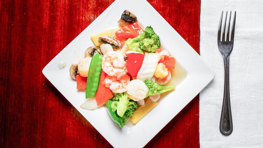 Shrimp & Scallops · Shrimp and scallops, sautéed with vegetables in a wine sauce.
