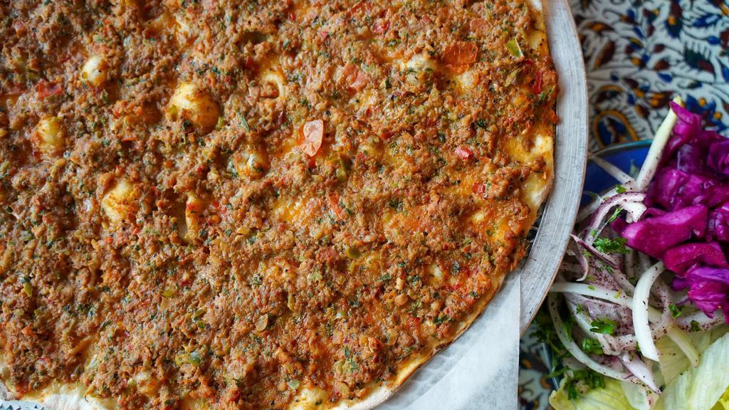 Lahmacun · House made dough, ground beef, tomato, green pepper, red pepper, onion, garlic, parsley and side of Lettuce, onion, red cabbage pickles and lemon