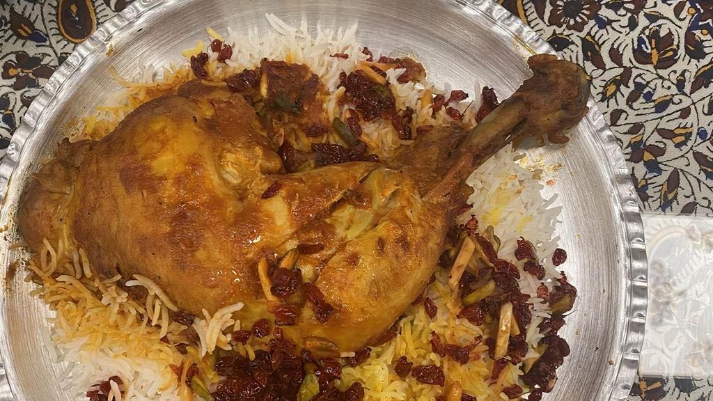 Zereshk Polo With Chicken · Half Chicken cooked in tomato sauce served with barberries mixed with saffron rice