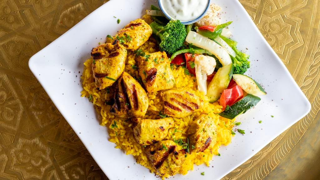 Chicken Kabob · Breast of chicken marinated with garlic, Marakesh spice blend, olive oil. Served with vegetables and saffron rice.