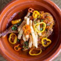 Tunisian Chicken · Half chicken on the bone stewed in Harissa sauce with Moroccan spice blend. Served with saff...