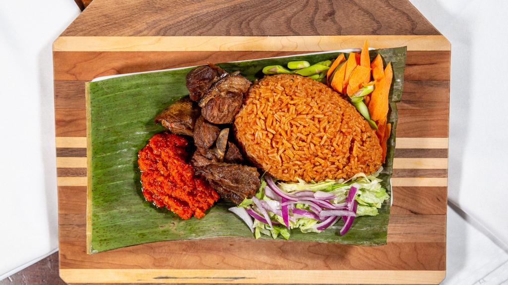 Chicken, Beef Or Goat Jollof · With grilled or fried tilapia for an additional charge.