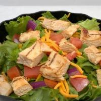 Chicken Salad · Chicken, fresh lettuce, tomatoes, onions, cheddar cheese, and dressing.