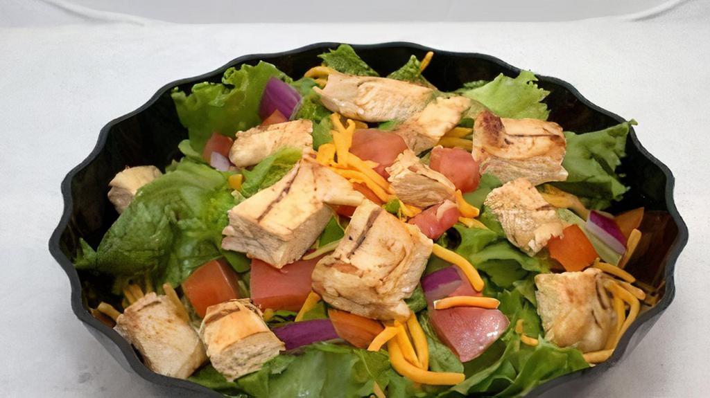 Chicken Salad · Chicken, fresh lettuce, tomatoes, onions, cheddar cheese, and dressing.