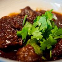 Nuer Ob · Slowly cooked beef chunks in Mam’s Special sauce w/ caramelized yellow onion, tomatoes, blac...