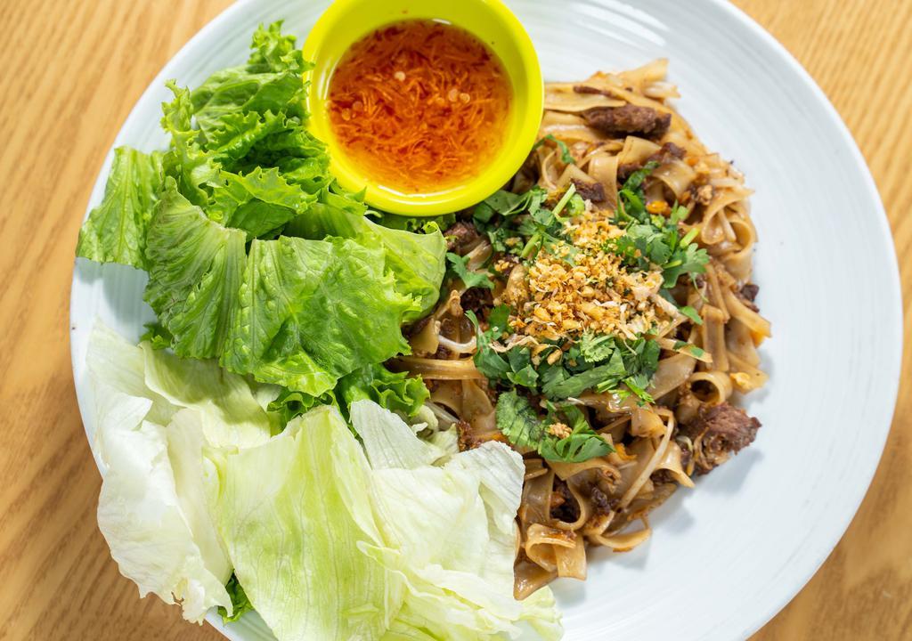 Guay Teaw Kua Gai · Stir-fried Flat rice noodle w/ eggs, bean sprout, pickled radish & mixed soy sauce. Served w/ green leaf lettuce, topped w/ fried garlic & cilantro.