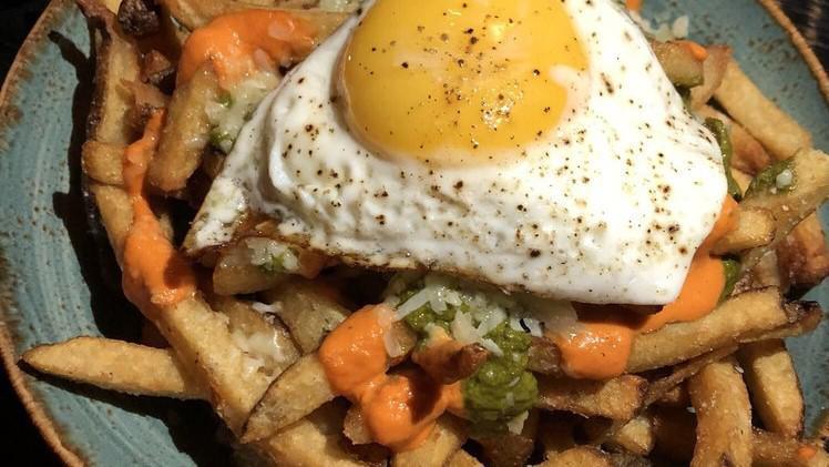 Catalan Fries · Romesco, chimichurri, manchego cheese, and sunny side up egg.