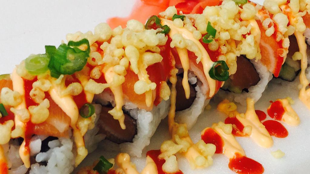 Deluxe Spicy Salmon Roll · Spicy crunchy salmon topped with salmon, spicy mayo, crunch, green onion and hot chili sauce. 8 pieces.