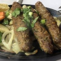 Sheesh Kebab · Minced lamb rolls cooked on a skewer over charcoal.