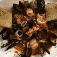Frutti Di Mare · Shrimp, scallops, mussels, calamari in a fresh tomato and white wine sauce, served over ling...