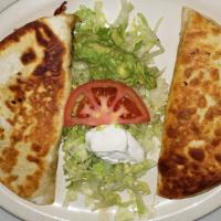Double Quesadilla · Flour tortillas, grilled with cheese and choice of grilled chicken or steak. Served with gua...