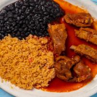 Costillas Con Salsa Roja · Homemade style spicy pork ribs cooked with red spicy sauce and served with rice, and black b...