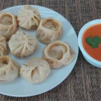 Chicken Momo · Steamed or Fried dumplings with various spices served with tomato chutney.