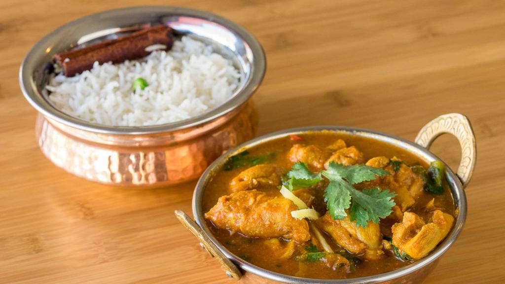 Chicken Curry · Boneless chicken cooked in a special curry sauce with herbs and spices. served with basmati rice on the side.