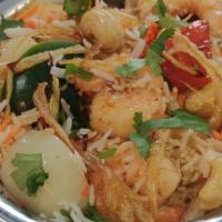 Shrimp Biryani · Basmati rice cooked with shrimp,, onion, bell pepper, cashew nuts. Served with Raita (Yoghur...