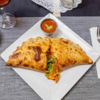 Butter Chicken Calzone · Slow cooked barbecued chicken in buttery cream sauce and mozzarella cheese.