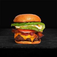 An Eggcellent Time Burger · Seasoned half-pound angus patty perfectly cooked to medium, topped with bacon, fried egg, av...