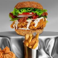 Chicken Deluxe Sandwich · Battered and fried white meat chicken, topped with bacon, cheese and crispy bacon with crisp...