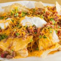 Bbq Nachos · Homemade tortilla chips, queso, choice of meat, jalapeño, and sour cream.