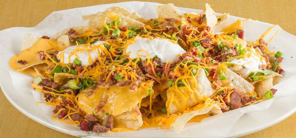 Bbq Nachos · Homemade tortilla chips, queso, choice of meat, jalapeño, and sour cream.