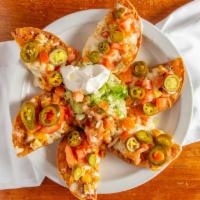 Mexican Nachos · Chicken or beef with refried beans, lettuce,
jalapenos, cheese, sour cream and salsa on
hous...