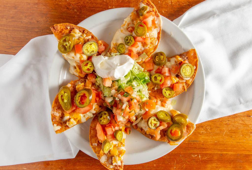 Mexican Nachos · Chicken or beef with refried beans, lettuce,
jalapenos, cheese, sour cream and salsa on
house corn tortillas.