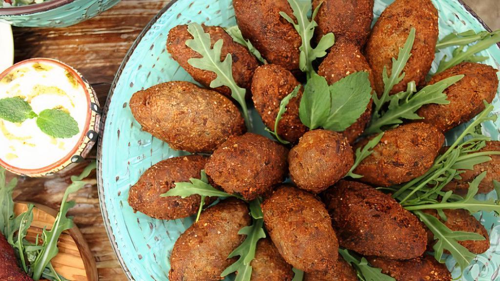 Kibbeh · Five pieces. Made of organic cracked wheat minced onions, lean ground beef, and topped off with spices like cinnamon, nutmeg, allspice, and clove.