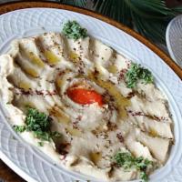 Hummus · Chickpeas blended with tahini, lemon juice, garlic, olive oil and served with pita.