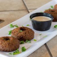 Falafel · Four patties of ground chickpeas mixed with spices and fried in vegetable oil.