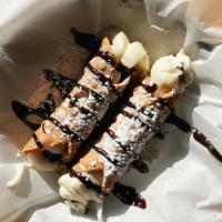 Cannoli · Cannolis stuffed with chocolate chip and ricotta cannoli cream filing, drizzled with chocola...