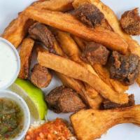 Yuca Con Chicharron · Fried Yucca with delicious fried pork Carne Asada or Chicken, served with cabbage and marina...