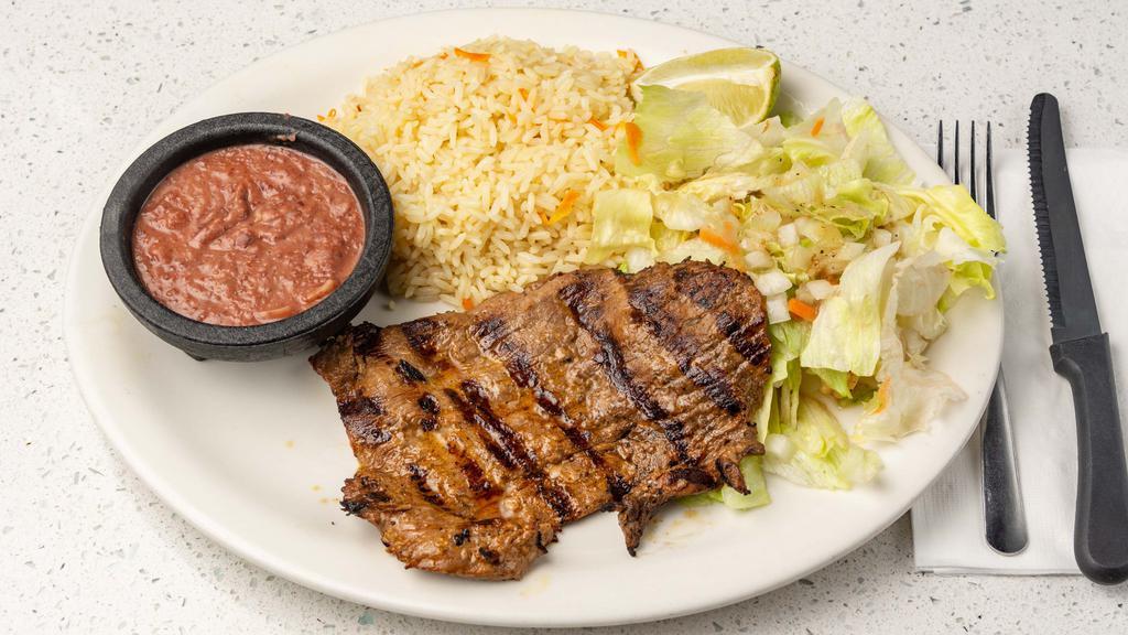 Carne Asada · Broiled Salvadoran style steak accompanied with refried beans, rice and salad.