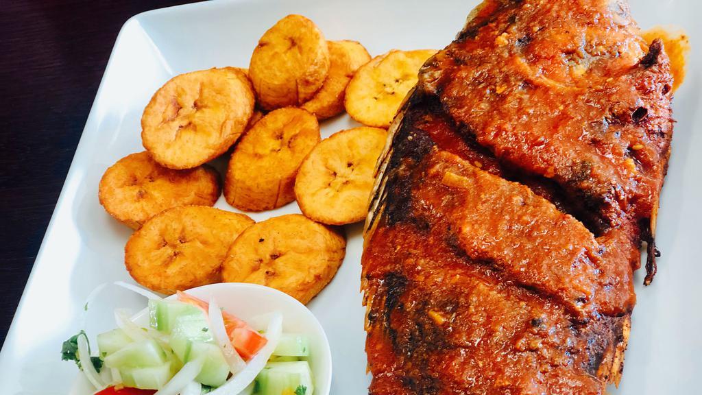 Tilapia Fish / Poisson Braise · Classic marinated whole Tilapia fish. Served with one side of your choice and salad.