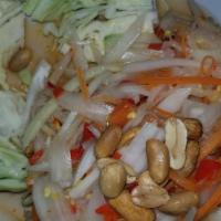 Papaya Salad · Shredded green papaya with tomato, garlic, carrot, and peanuts in lime sauce. Served with ca...