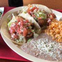 2 Fish Tacos (White Fish) · Two battered fish tacos on corn tortilla topped with Tatar sauce ,lettuce and pico de gallo ...