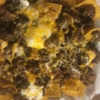 Carne Asada Chips · With cheese, guacamole, sour cream, beans, Mexican salsa and meat.