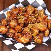 Garlic Soy Chicken · Bite sized double fried marinated chicken bites tossed and glazed in our signature savory ga...