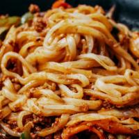 Spicy Pork Noodles · Ground pork, scallions, onions, cabbage, zucchini, and carrots stir-fried into a savory sauc...