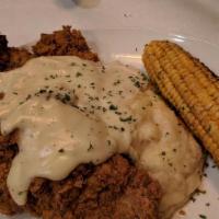Chicken Fried Steak · Topped with country gravy and served with white cheddar mashed potatoes.