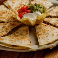 Quesadillas · Grilled, homemade flour tortillas stuffed with chicken, beef, or shrimp fajita and melted mo...