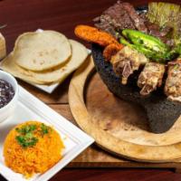 Molcajete · Served with fundido cheese, steak, chicken, chorizo, pork ribs, cactus, jalapeño pepper, ceb...
