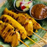 Chicken Satay · Grilled marinated chicken on skewers served with peanut sauce and cucumber salad.