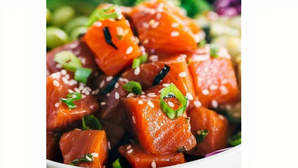 Salmon Poke Bowl · Spicy. Salmon pokini, rice, cucumbers, avocados, carrots, jalapenos, edamame, scallions, poke sauce and sesame seeds.