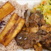 Oxtails · Cooked until tender  in a  rich brown gravy  with butter beans. Served with rice and peas an...