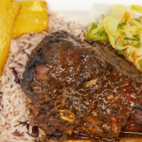 Jerk Chicken · Jamaican classic marinated and grilled served with rice and peas and sautéed cabbage