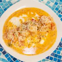 Shrimp & Grits  · Cajun spiced shrimp sautéed in peppers onion and tomato's in a creamy sauce over buttery che...