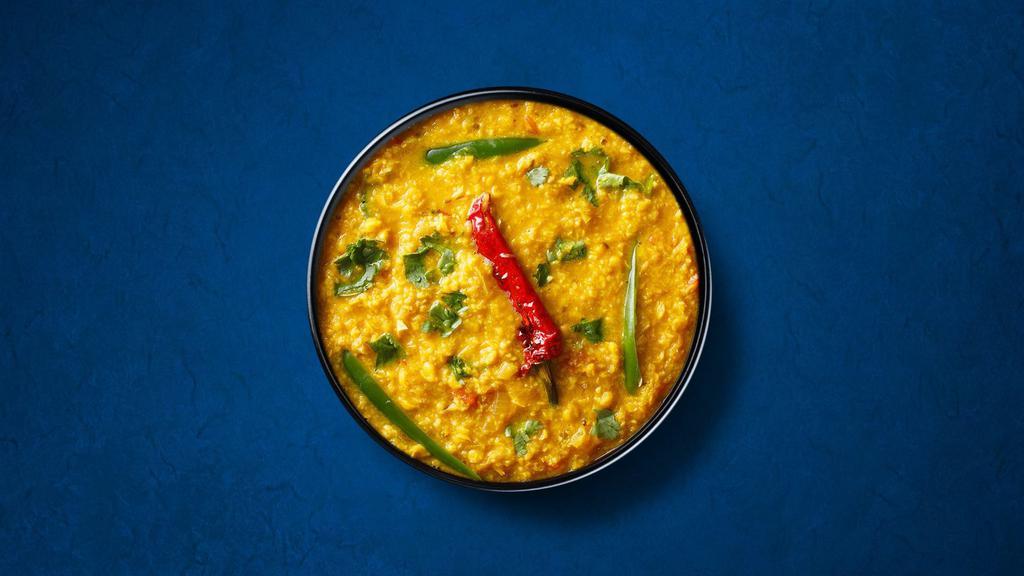 Divine Yellow Lentils  · Yellow lentils, slow-cooked to perfection and tempered with cumin, garlic, and chilies.